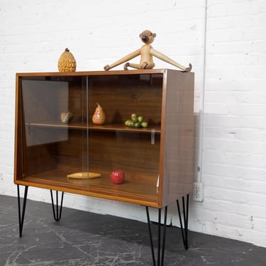 Vintage MCM walnut wood small storage cabinet on hairpin legs w/ sliding glass doors | Free delivery only in NYC and Hudson Valley areas 