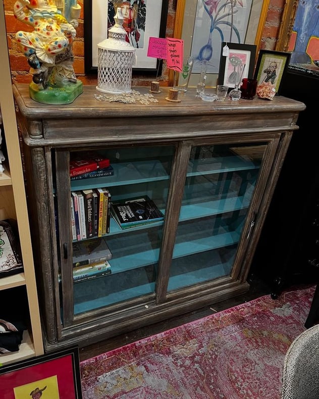 Glass front cabinet. 50” x 13.5” x 48.5” 