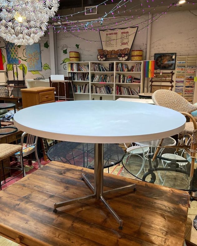 Chrome based round laminate top table. 48.5” round 31.5” tall