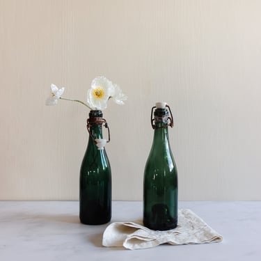 pair of vintage french green glass porcelain top bistro bottles