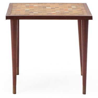 End table with a orange and brown tile motif on tapered teak dowel legs