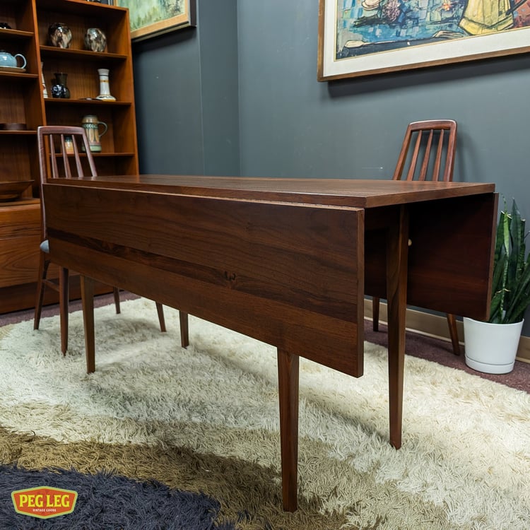 Mid-Century Modern walnut drop-leaf dining table with rosewood details