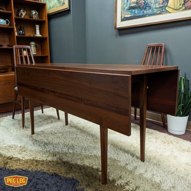 Mid-Century Modern walnut drop-leaf dining table with rosewood details