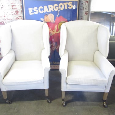 PAIR PRICED SEPARATELY OF RESTORATION HARDWARE WINGBACK CHAIRS ON CASTERS
