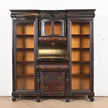 R. J. Horner Style Victorian Mahogany Glass Front Triple Bookcase With Drop Front Secretary Desk and Carved Lions, Circa 1890s