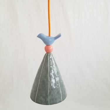 Small pendant light. Ceramic w/bird. Hangs 15' plug in cord 