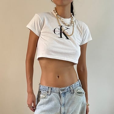 90s Calvin Klein tee / true vintage white cotton Calvin Klein designer spell out ultra cropped t-shirt tee Made in USA  | Small Medium 