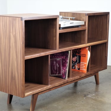 Mid-century modern stereo console for a record player and record storage. The 