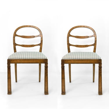 Pair of Swedish Grace arched back chairs with obelisk front legs.
