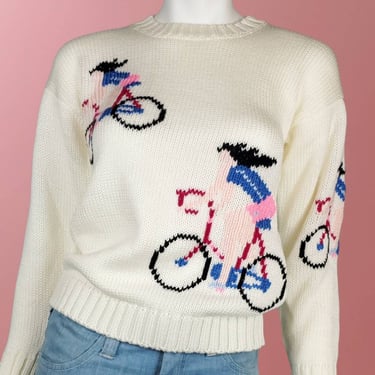 Deadstock girl on bicycle sweater. Vintage from the 1970s. Novelty cutesie knit pullover crew neck. (S) 