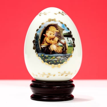 VINTAGE: 1994 - Off White Porcelain Egg with Wood Stand - Umbrella Boy - The M. J. Hummel Porcelain Egg Collection - SKU 15-F1-00013766 