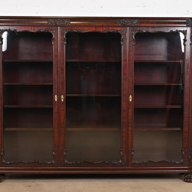 R. J. Horner Style Victorian Carved Mahogany Glass Front Triple Bookcase, Circa 1890s