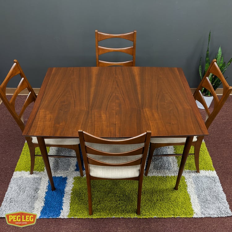 Mid-Century Modern walnut dining table with self-storing leaf