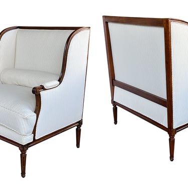 A Pair of French Louis XVI Carved Walnut Wingback Marquise Armchairs