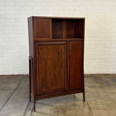 Walnut bookcase with exposed legs 