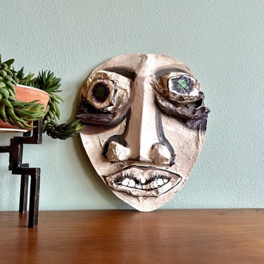 Large, wacky paper mache mask wall hanging / handmade outsider art green-eyed face 