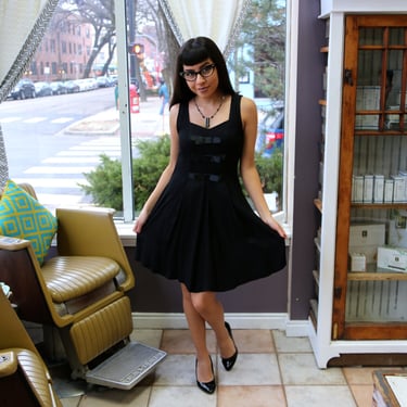 Vintage (1960s Inspired) Be Smart Sleeveless Little Black Dress with Bows and Pleated Skirt 