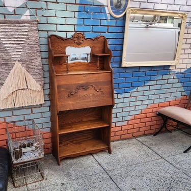 Oak Larkin Desk. Drop Front Desk Surface with Compartments, original mirror in splash board, candle stands, two shelf Bookcase below desk. 