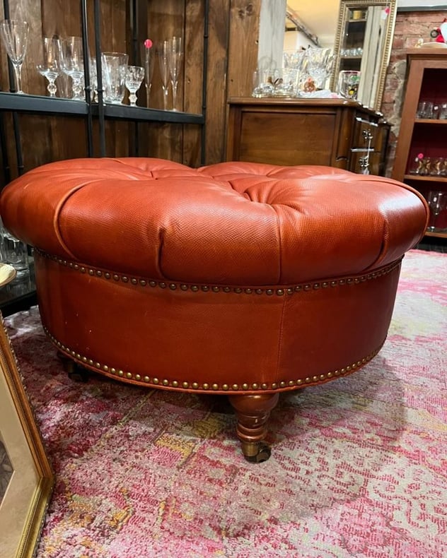 Big tufted ottoman or living room island on wheels. 33” across 18” tall. 