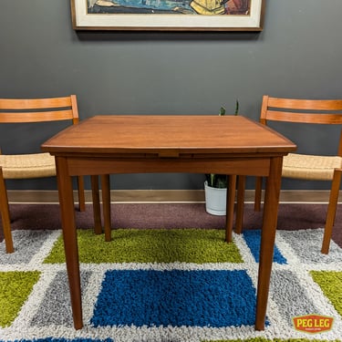 Danish Modern teak draw-leaf dining table with flip-top game surface