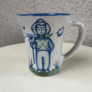 Vintage M.A. Hadley pottery flared shape mug white blue farmer man theme holds 12 oz 