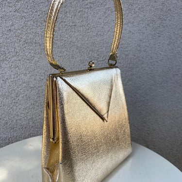 Vintage Wounded Bird gold faux Leather metallic hand bag by ila of California. Interior pockets size 8” x 8.5” x 4” 