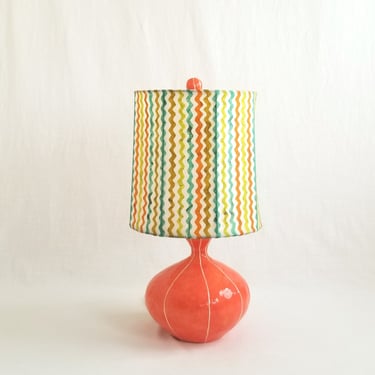 Ceramic table lamp lamp in coral red. Custom handmade striped shade and finial 