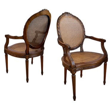 Pair Louis XVI Style Carved Walnut Arm Chairs with Caned Back & Seat