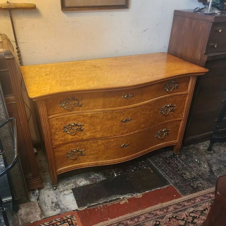 Vintage Serpentine Front Three Drawer Dresser. Birds Eye Maple, locks on all three drawers with key, Brass Pulls, Ornaments, and Casters, chamfered side panels. 48x24x31" tall. Circa 1930. 