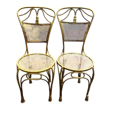 Vintage pair of metal gilt chairs with rope and  tassel design - mesh seats and backs 