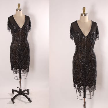 Late 1980s Early 1990s Black Sequin and Beaded Fringe Short Sleeve Flapper Style Sheer Nude Illusion Dress by Peak Evenings -M 