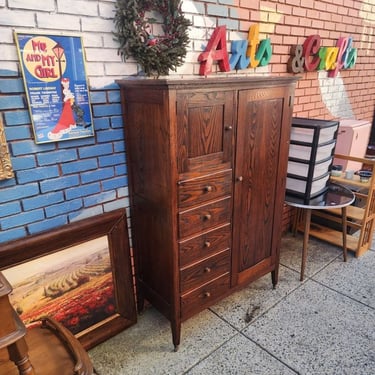 Early 20th Century Chifferobe. Mission highlights/Art and Crafts tone. Bar to hang clothing, Hat Box, 5 drawers. Looks like Chestnut w very active grain pattern. On casters. 