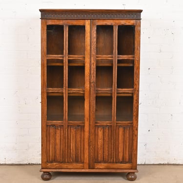 Antique English Tudor Carved Oak Glass Front Bookcase Cabinet, Circa 1920s