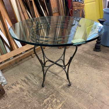 Round glass table on steel legs, 30 x 37 3/4”