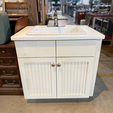 Freestanding Sink with Faucet Hardware and Beadboard Paneled Cabinet Base