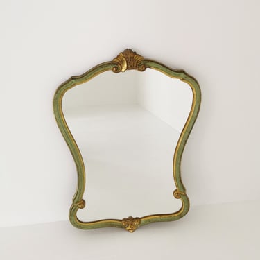 Classic style mirror in gold leaf with shaped frame  Italy 1980s. 