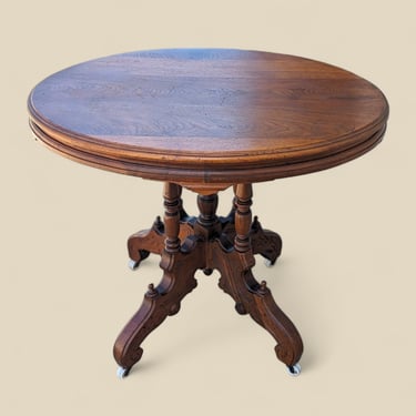 Antique Victorian Parlor Table, Ornate Carved Wood Round Top on Casters, Elegant Accent Piece for Living Room or Entryway Decor 