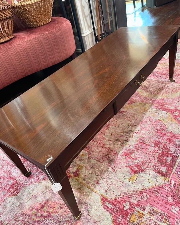 Mersman sleek and long mahogany coffee table with wheels. 48x17.75x16” 