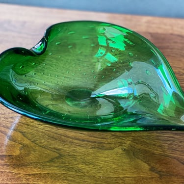 MCM tabletop decor. A green blown glass bowl, leaf shaped with controlled bubbles. A Mid century modernist collectible decoration. 