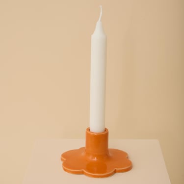 Orange handmade ceramic candle holder with scalloped edge 