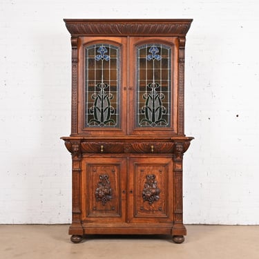 Antique French Renaissance Revival Carved Oak Breakfront Bookcase or Bar Cabinet With Stained Glass Doors