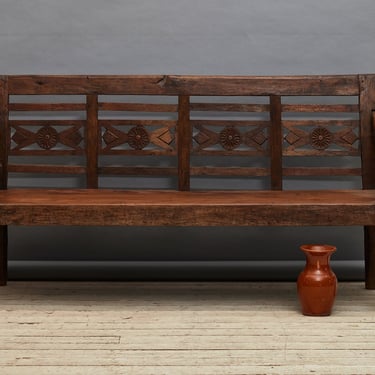 Teak Dutch Colonial Thick Bench from Sumatra with a Carved Flower Motif in the Back Medallion