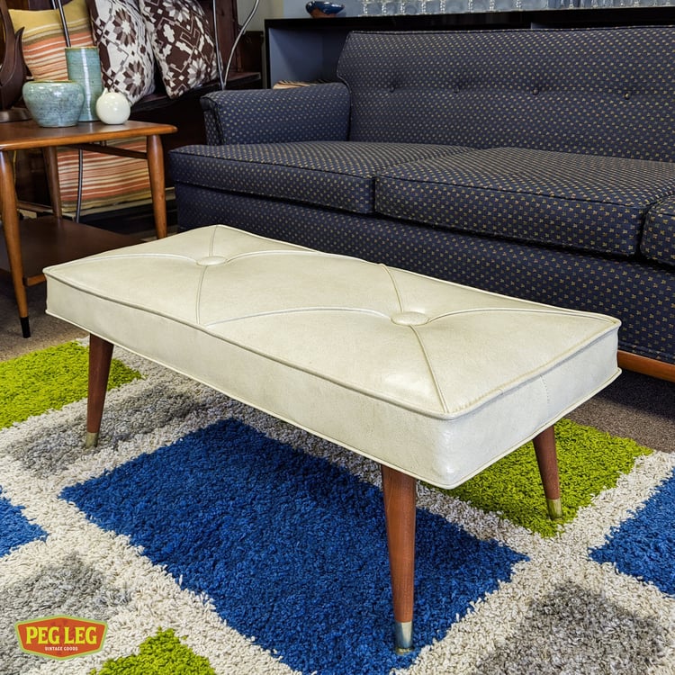 Mid-Century Modern ottoman/bench with vinyl upholstery and walnut legs