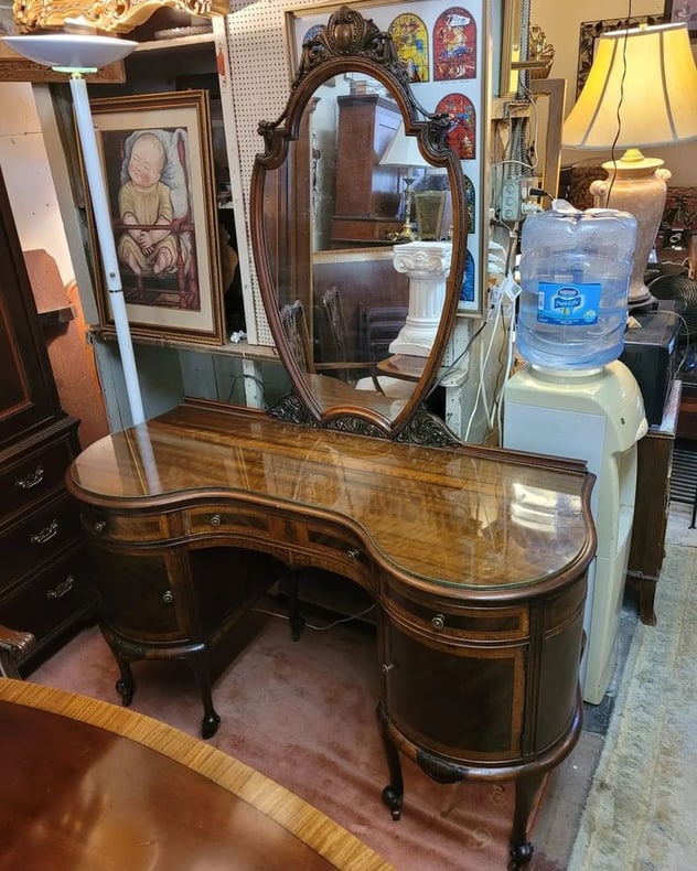 Rare Vintage French Style Kidney Top Vanity or Desk. With plate glass top, inlaid drawer faces, carved mirror frame and casters.…