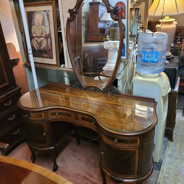 Rare Vintage French Style Kidney Top Vanity or Desk. With plate glass top, inlaid drawer faces, carved mirror frame and casters.…