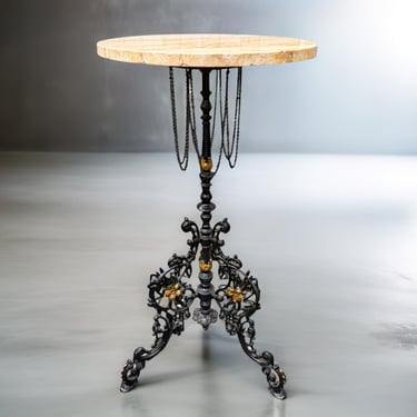 Victorian cast iron side table with ornate floral base, gold accents and travertine top – Hollywood Regency flair 