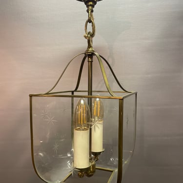 Brass 2 bulb foyer light with starburst details on the glass