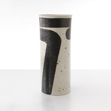 A tall Inger Persson vase with a bold stripe on a white ground