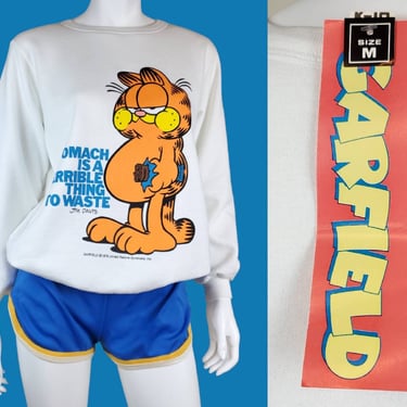 1978 GARFIELD sweatshirt.  Deadstock with original tags. "A Stomach Is a Terrible Thing To Waste" White, blue, yellow, orange. (S/M) 