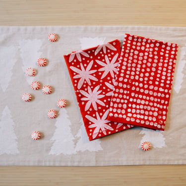 white pebbles on red. block printed linen napkins / placemats / tea towels. set of four. boho christmas party. holiday decor. snow. winter. 